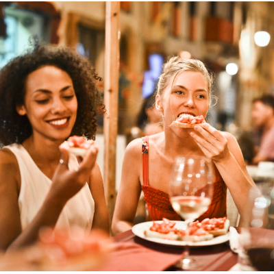 Two people sharing bruschetta at a restaurant