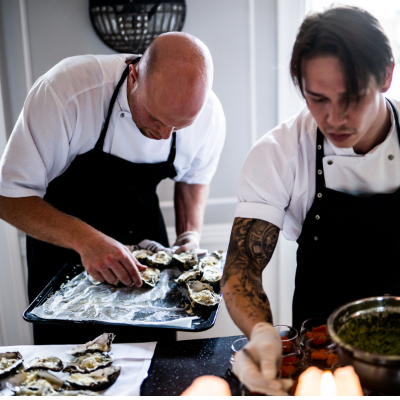 Two chefs working on plating